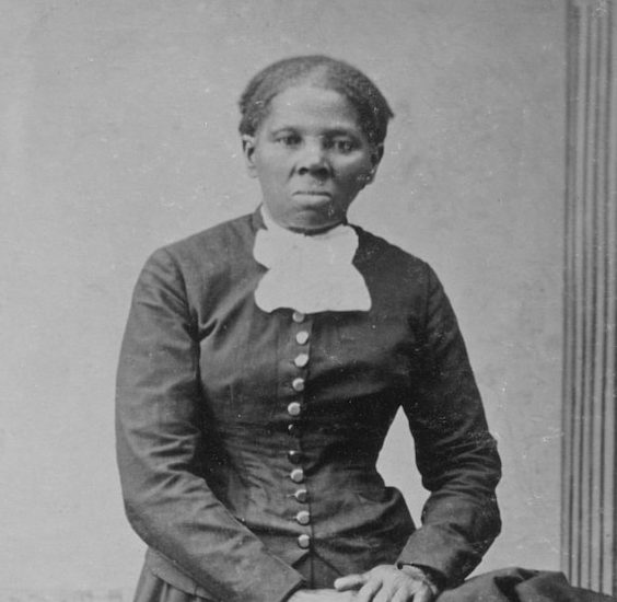 an old black and white photo of a woman in a dress